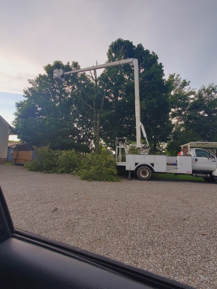 RJ's Tree Care bucket truck on site working a tree removal job